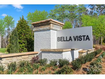 Community entrance sign for Bella Vista featuring brick pillars and manicured landscaping at Lot#143 Northwood Ct, Denver, NC 28037