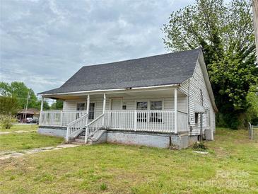 Traditional home featuring a cozy porch and classic architecture, ideal for renovation at 104 E Church St, Dallas, NC 28034