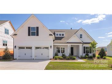 Charming two-story home featuring a two-car garage, landscaped yard, and welcoming front porch at 13063 Arnold Palmer Cir # 839, Lancaster, SC 29720