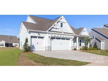 Charming home with a three car garage, stone accents, and a well-maintained lawn at 13279 Arnold Palmer Cir # 867, Lancaster, SC 29720