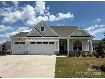 Charming one-story home with a three-car garage and well-manicured lawn at 13279 Arnold Palmer Cir # 867, Lancaster, SC 29720