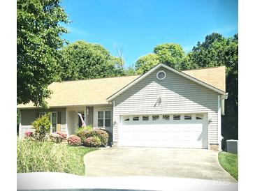 Charming ranch-style home with a two-car garage, lovely landscaping, and a welcoming curb appeal at 317 Robert Keever Rd, Stanley, NC 28164