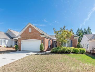 Charming one story brick home with a two car garage and well manicured landscaping at 43014 Mimosa Ct, Indian Land, SC 29707
