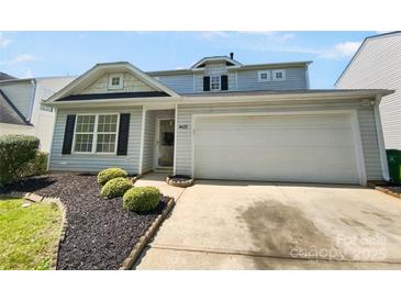 Charming home features a 2-car garage and beautiful landscaping with a well-maintained lawn and decorative bushes at 4437 Devonhill Ln, Charlotte, NC 28269