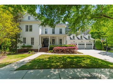 Charming two-story home features a landscaped yard, covered porch, and three car garage at 5868 Savona Ter, Fort Mill, SC 29708