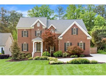 Charming two-story brick home with a lush front yard and well-maintained landscaping, providing great curb appeal at 6201 Creola Rd, Charlotte, NC 28270