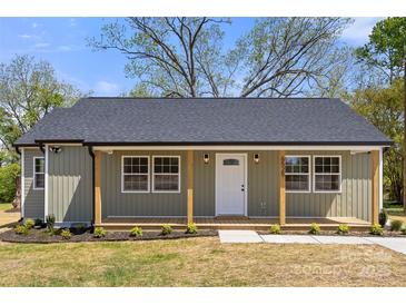 Charming home featuring a welcoming front porch with wooden posts and a beautifully landscaped yard at 6525 Kershaw Camden Hwy, Heath Springs, SC 29058