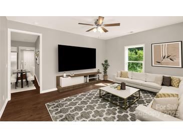 Bright living room featuring a large screen television, stylish furniture, and contemporary decor at 119 Washington St, York, SC 29745