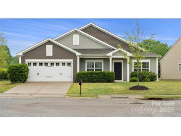 Charming single-story home with a two-car garage and well-manicured front yard at 13012 Hunting Birds Ln, Charlotte, NC 28278
