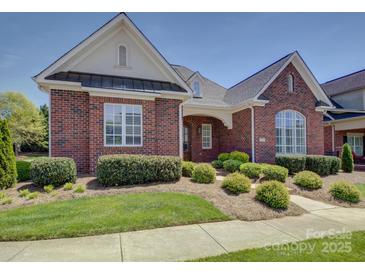 Charming brick home with manicured lawn, lush bushes, and a covered entryway at 324 Quinby Way, Rock Hill, SC 29732
