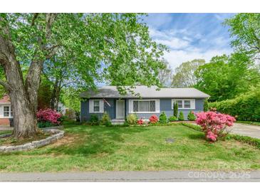 Charming single-story home featuring a well-maintained lawn, lush landscaping, and a classic exterior at 400 Rhyne St, Stanley, NC 28164
