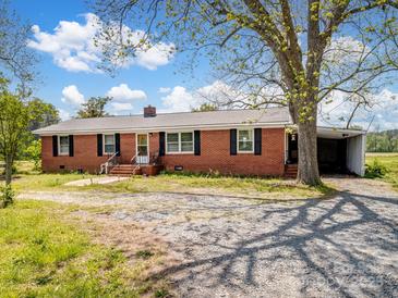 Charming brick ranch with mature trees and a covered parking area at 7516 Pageland Hwy # 3, Monroe, NC 28112