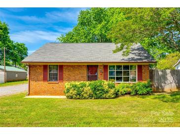 Charming brick home featuring manicured landscaping, red shutters, and a well-maintained lawn at 862 Eastwood Dr, Rock Hill, SC 29730