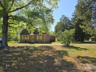 Charming brick home with mature trees and a spacious front yard at 8860 Castor Rd, Salisbury, NC 28146
