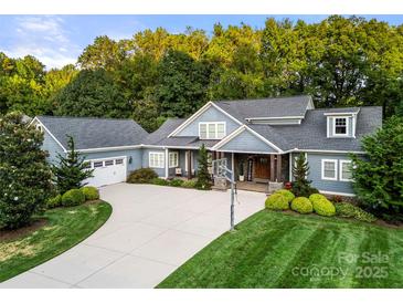 Stunning home with beautiful landscaping, a long driveway and attached two car garage at 1068 Grant Dr, Denver, NC 28037