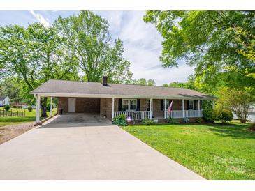 Charming single story brick home with a covered front porch, carport, and well-manicured lawn at 111 Peoria Ln, Kings Mountain, NC 28086
