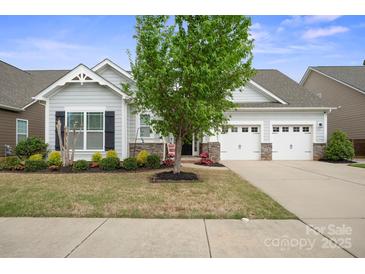 Charming single Gathering home featuring a two-car garage and a beautifully landscaped front yard at 13115 Union Square Dr, Huntersville, NC 28078