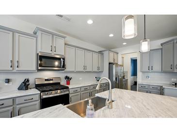 Bright kitchen with stainless steel appliances, modern cabinetry, and a marble countertop island at 1578 Whitman Ct, York, SC 29745