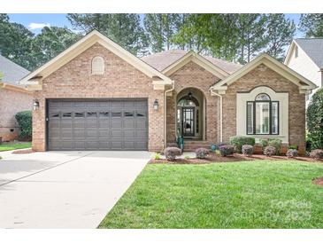 Charming single-story brick home featuring a two-car garage and well-maintained landscaping at 17408 Summer Place Dr, Cornelius, NC 28031