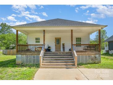Inviting home featuring a covered porch and a well-maintained front yard at 209 Sheffield Dr, York, SC 29745