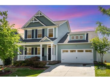 Charming two-story home with a welcoming front porch and a spacious two-car garage at 4406 Huntley Glen Dr, Pineville, NC 28134