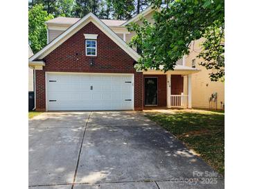 Charming two-story home with a brick facade, a two-car garage, and a well-maintained front yard at 616 Mountain Quail Dr, Charlotte, NC 28216