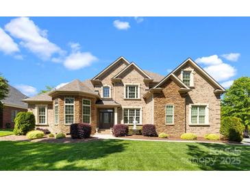 Stunning brick and stone home with manicured lawn and charming water fountain at 630 Deberry Holw, Rock Hill, SC 29732