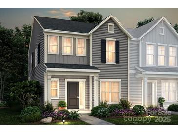 Charming two-story gray home with black shutters, front garden and a welcoming front door at 10033 Guardian Dr # 265, Charlotte, NC 28273