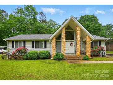 Charming home featuring a unique entryway with stone pillars and beautifully landscaped front yard at 116 Pelham Ln, Fort Mill, SC 29715