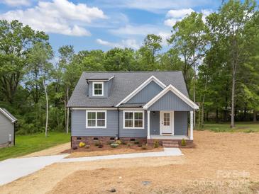 Charming blue home with a well-manicured lawn and inviting front entrance at 130B Springway Dr, Kannapolis, NC 28081