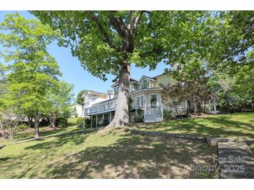 Large home with ample deck space surrounded by mature trees and landscaping at 17333 Saranita Ln, Charlotte, NC 28278