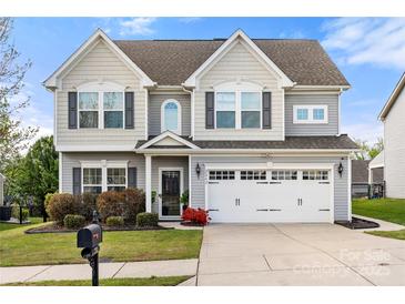 Charming two-story home with a well-manicured lawn, neutral siding, and a two-car garage at 2262 Galloway Sw Ln, Concord, NC 28025