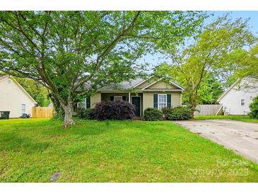 Charming single-story home with lush green lawn, mature trees, and a cozy, inviting facade at 2290 Kestrel Dr, Rock Hill, SC 29732