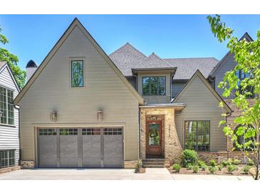 Charming home with a two car garage, brick accents, and a well manicured lawn at 3473 Willow Oak Rd, Charlotte, NC 28209