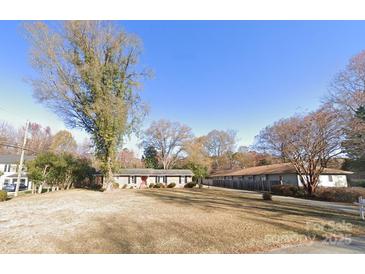 Charming single-story home with a well-maintained front yard and mature trees at 4312 Tantilla Cir, Charlotte, NC 28215