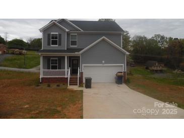 Charming two-story home featuring a well-manicured lawn and inviting front porch at 574 30Th Avenue Ne Cir, Hickory, NC 28601