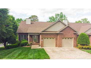 Charming brick home with a two-car garage and a well-manicured lawn at 904 3Rd Street Ne Pl, Conover, NC 28613