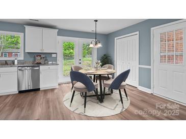 Bright dining area features stylish chairs, a modern chandelier, and view to the backyard at 1195 Ralph B Keener Rd, Lincolnton, NC 28092