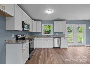 Bright kitchen with white cabinetry, stainless steel appliances, and granite countertops at 1195 Ralph B Keener Rd, Lincolnton, NC 28092