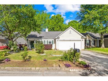 Charming single-story home with a well-manicured lawn and mature trees at 12305 Portrush Ln, Charlotte, NC 28273