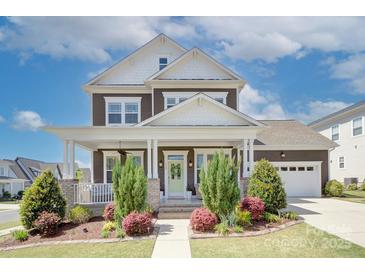Charming two-story home with a covered front porch and well-manicured landscaping at 1528 Half Pint Loop, Fort Mill, SC 29708