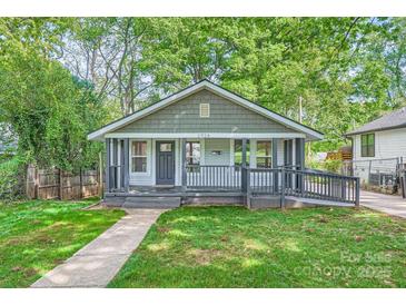 Charming bungalow with a welcoming front porch and lush green lawn, perfect for relaxing outdoors at 2924 Parkway Ave, Charlotte, NC 28208