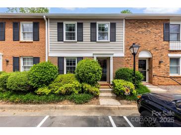 Charming townhome featuring a brick and siding exterior with well-maintained landscaping and black shutters at 4605 Hedgemore Dr # I, Charlotte, NC 28209