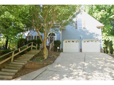 Charming two-story home featuring a two-car garage and landscaped front yard with mature trees at 4704 Beech Crest Pl, Charlotte, NC 28269