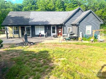 This home boasts a spacious backyard perfect for entertaining, complete with a large patio area at 605 Brookside Dr, Monroe, NC 28110