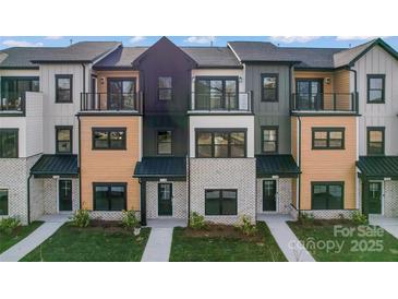 Beautiful modern townhomes featuring a variety of exterior finishes, balconies, and well-maintained landscaping at 714 Falling Oak Aly # 18, Huntersville, NC 28078