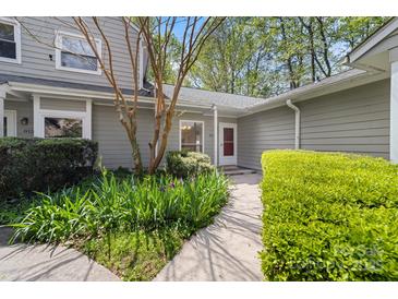 Charming front entrance with a well-manicured garden and inviting walkway, showcasing curb appeal at 817 Sardis Cove Dr, Charlotte, NC 28270