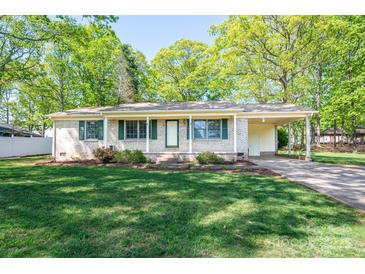 Charming brick ranch home with a well-manicured lawn, cozy front porch, and convenient carport at 1 Horace Grigg Cir, Shelby, NC 28152