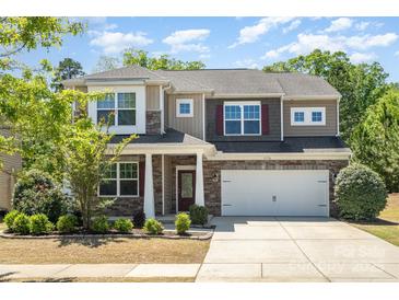 Beautiful two-story home featuring stone accents, well-kept landscaping, and an attached two-car garage at 1176 Shiloh Bend Trl, Fort Mill, SC 29715