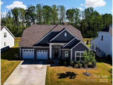 Charming home boasts a three-car garage, well-manicured lawn, and inviting curb appeal at 12512 Journeys End Trl, Huntersville, NC 28078
